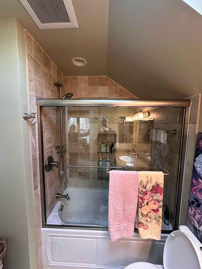Remodeled bathroom with a tile shower and sliding glass doors in Woodbine Maryland.